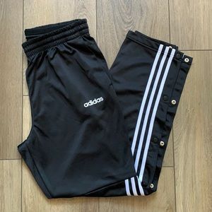 Adidas pants buttons on lower side.